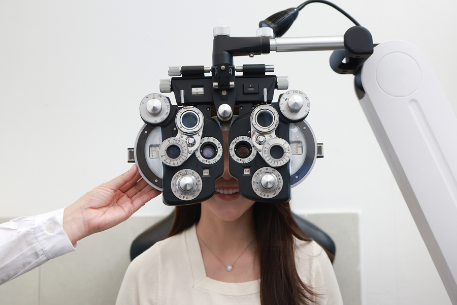 Person smiling during a vision exam.
