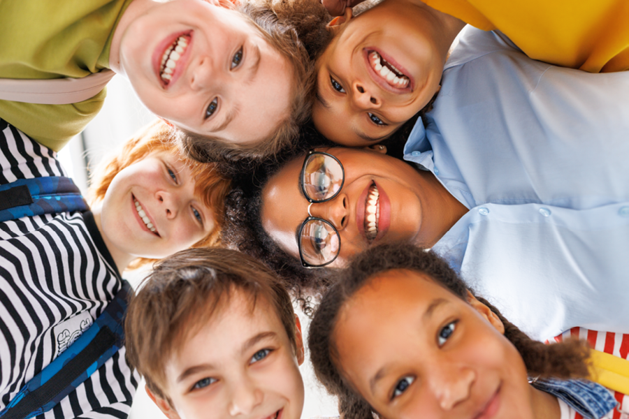 Group of children smiling together.