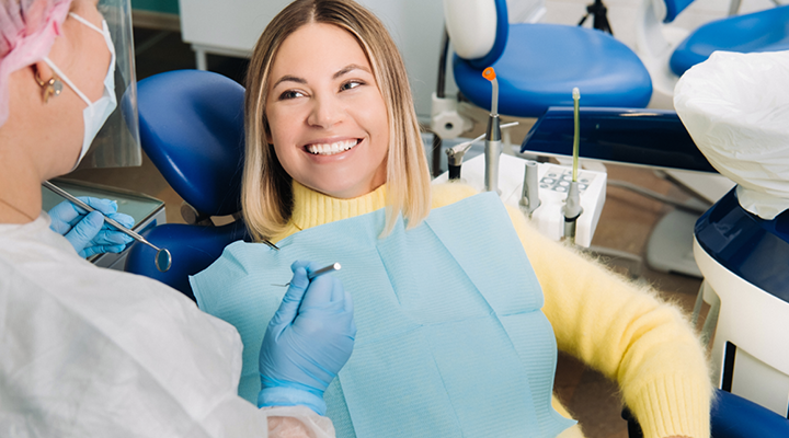 image of woman smiling sitting in dental chair