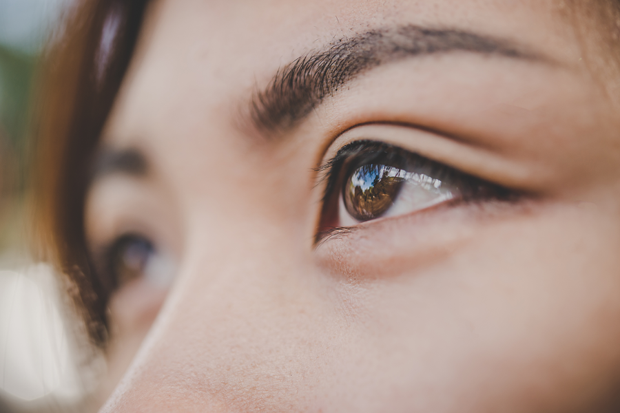 A close up of a woman's left eye as she looks off into the distance from right to left.
