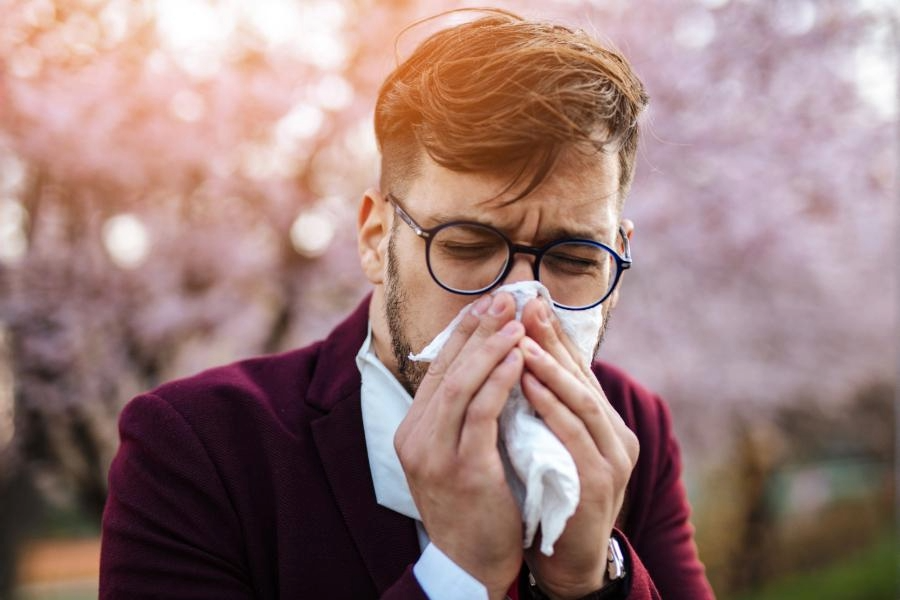 man blowing his nose